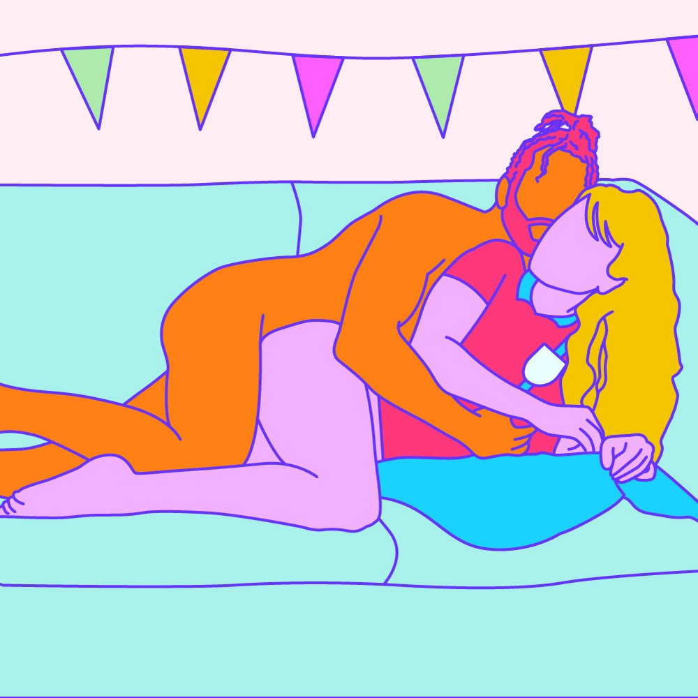 A naked illustrated couple lying on their sides together and cuddling on the couch.