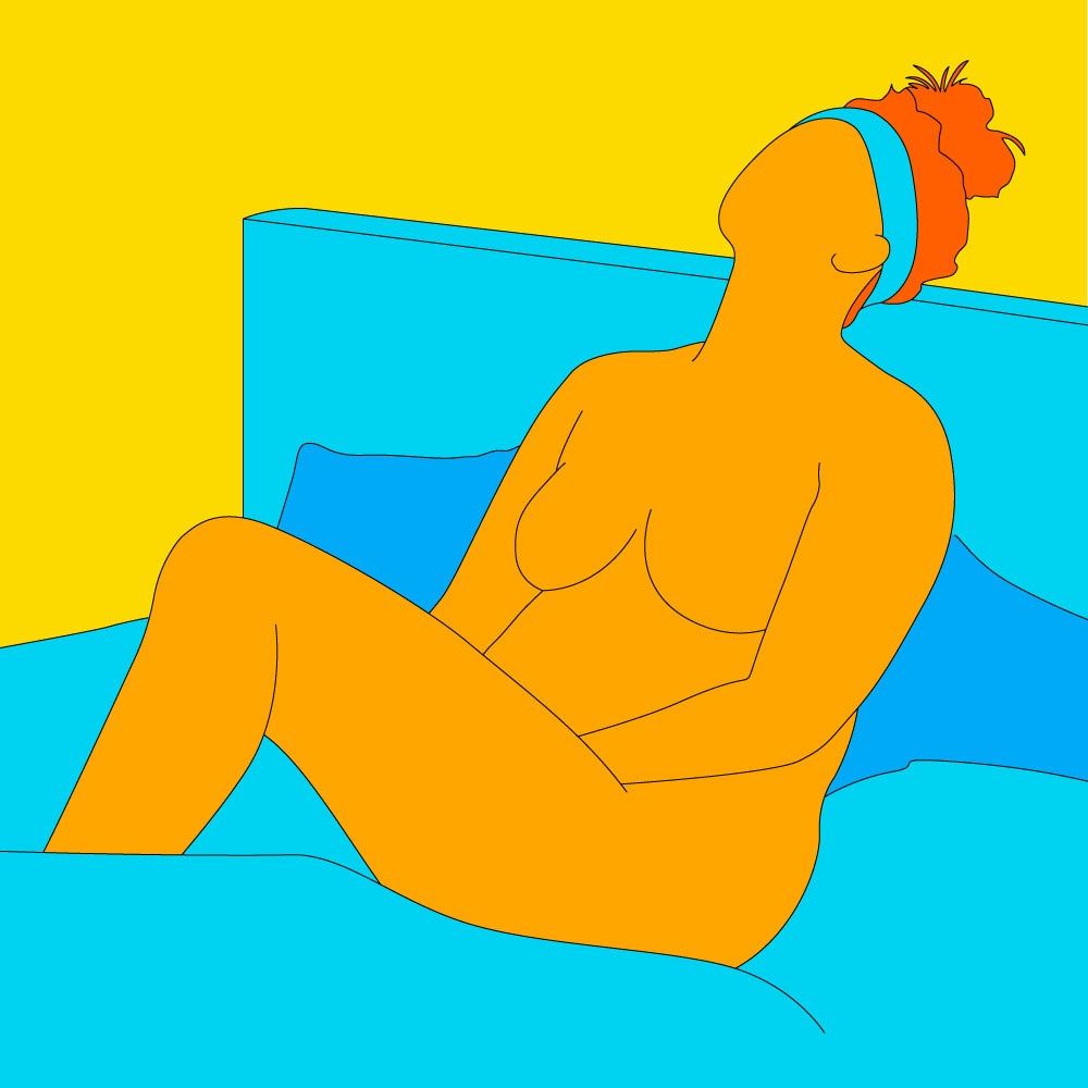 A naked illustrated woman sat on a bed, wearing a headband and touching herself.