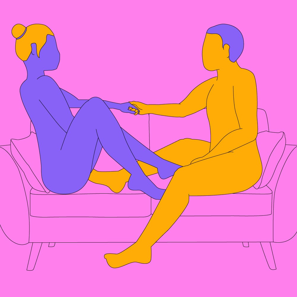 A naked illustrated couple sat opposite each other on a couch, holding each other's hand and looking into each other's eyes.