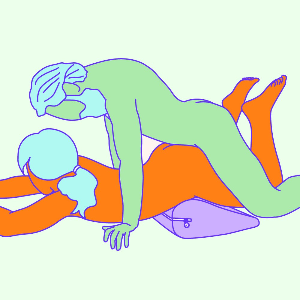 An illustrated position where the receiver is lying on their front, with a wedge under their hips, while the giver is entering from behind.