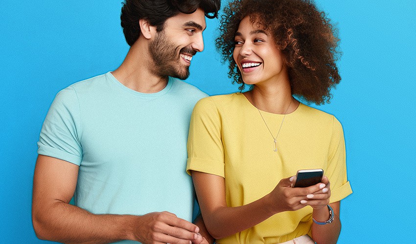 A photograph of a man and woman smiling at each other.