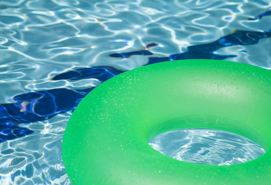 Bright green pool float floating in a pool